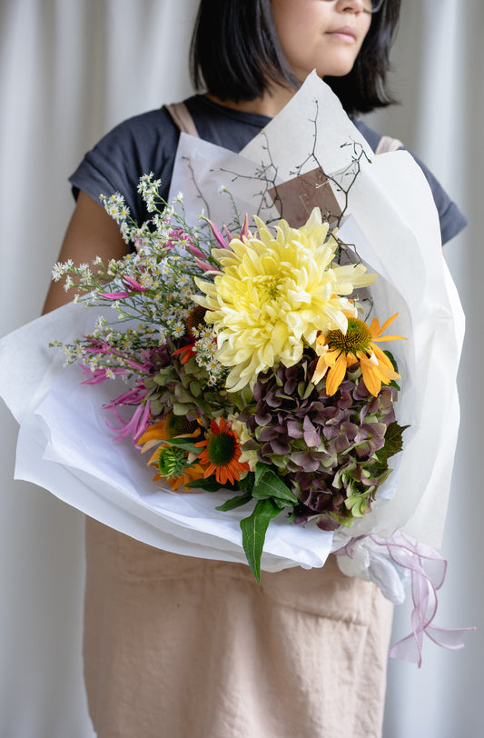 Florist holding bunch of flowers